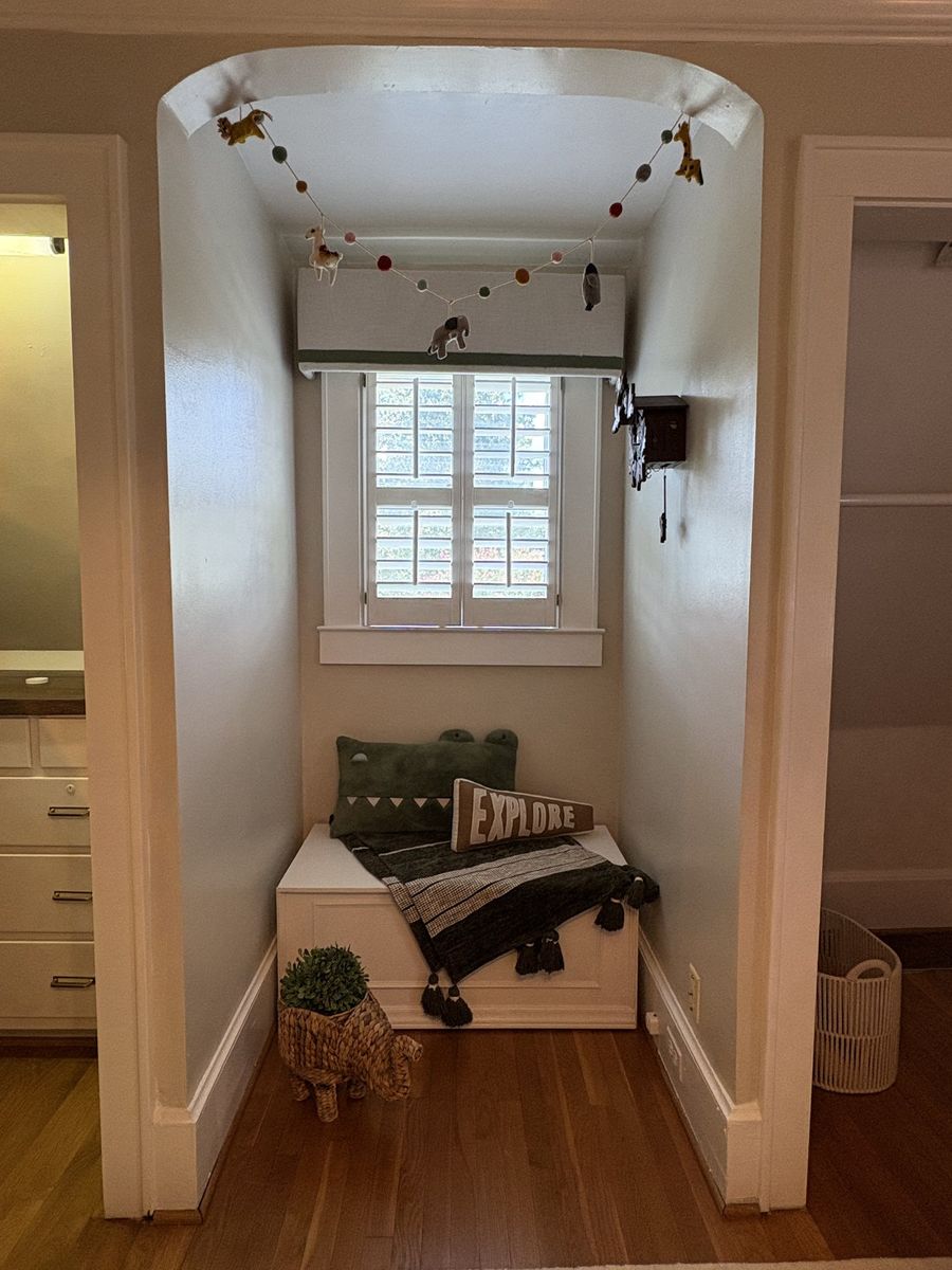 After: window nook with a storage bench, cushions, and an animal garland